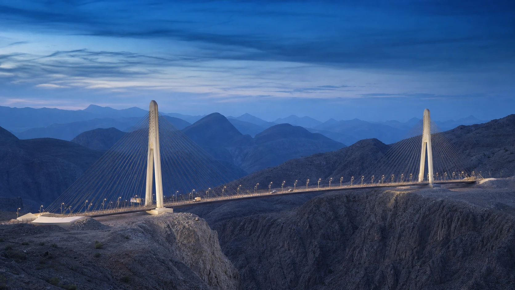 Oman Cable-Stayed Bridge spanning the mountain landscape at blue hour